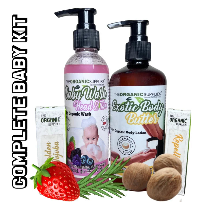 Complete organic baby care kit with shampoo, lotion, and wash besides strawberries tea tree leaves. golden jojoba oil bottle 